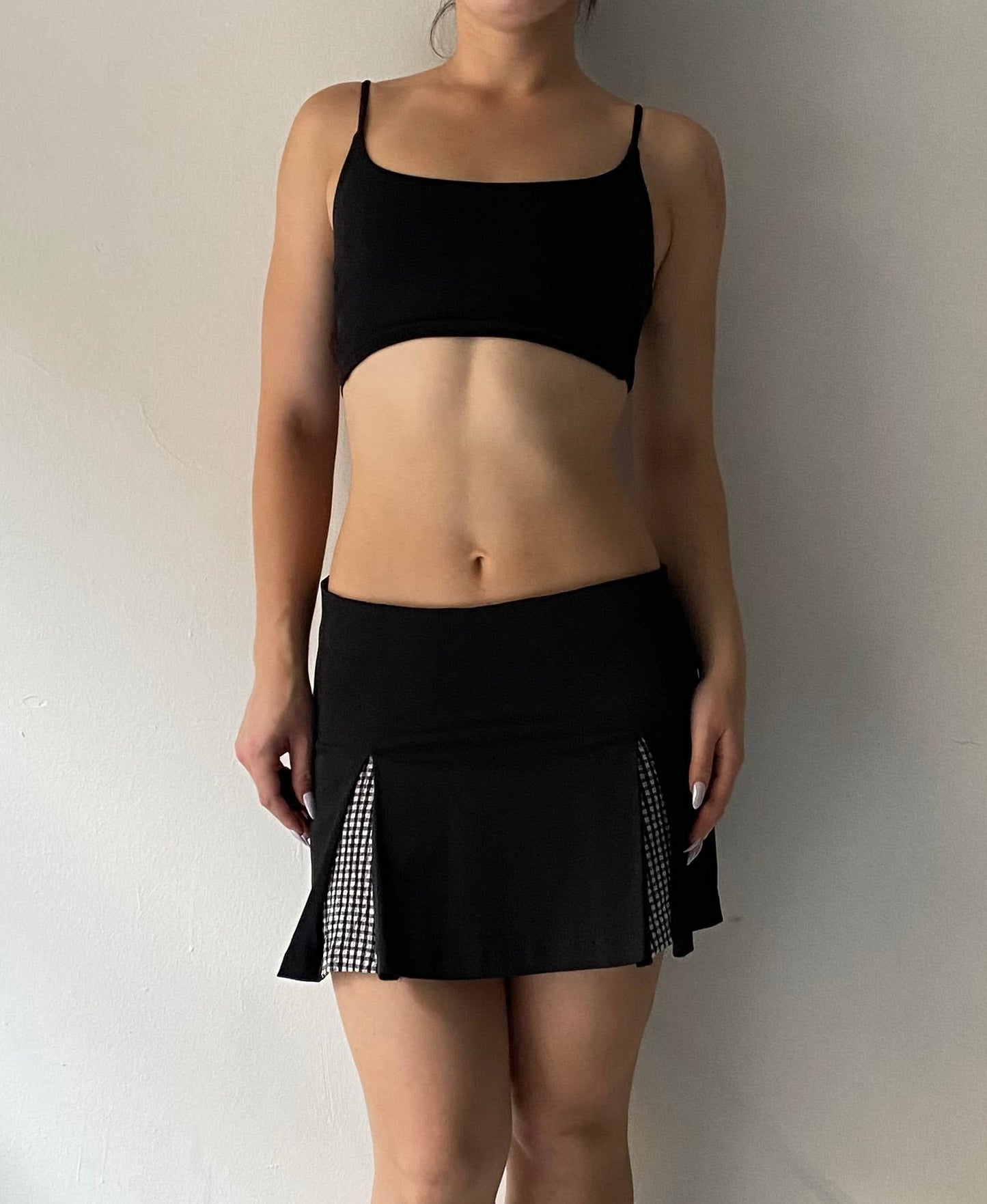 Black pleated mini skirt with plaid details